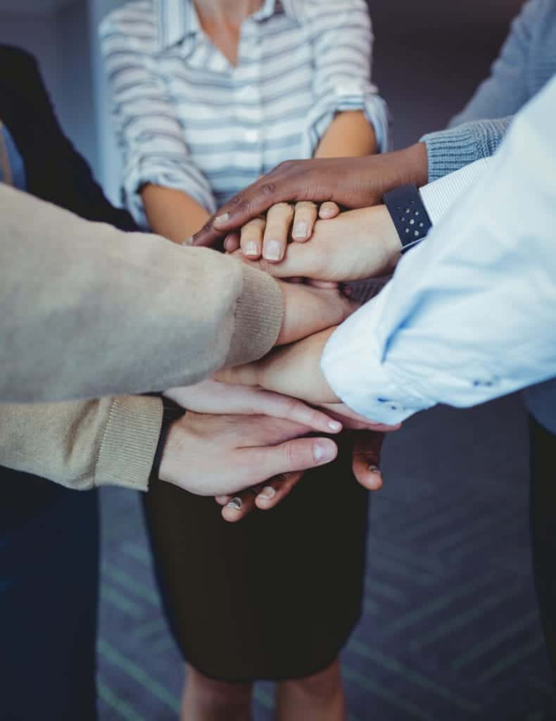 Business colleagues stacking hands