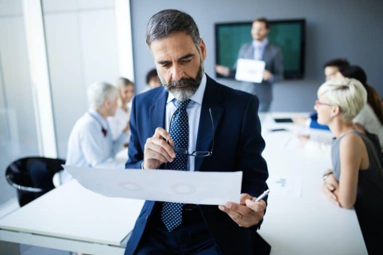 Shot of thinking financial advisor businessman working in office